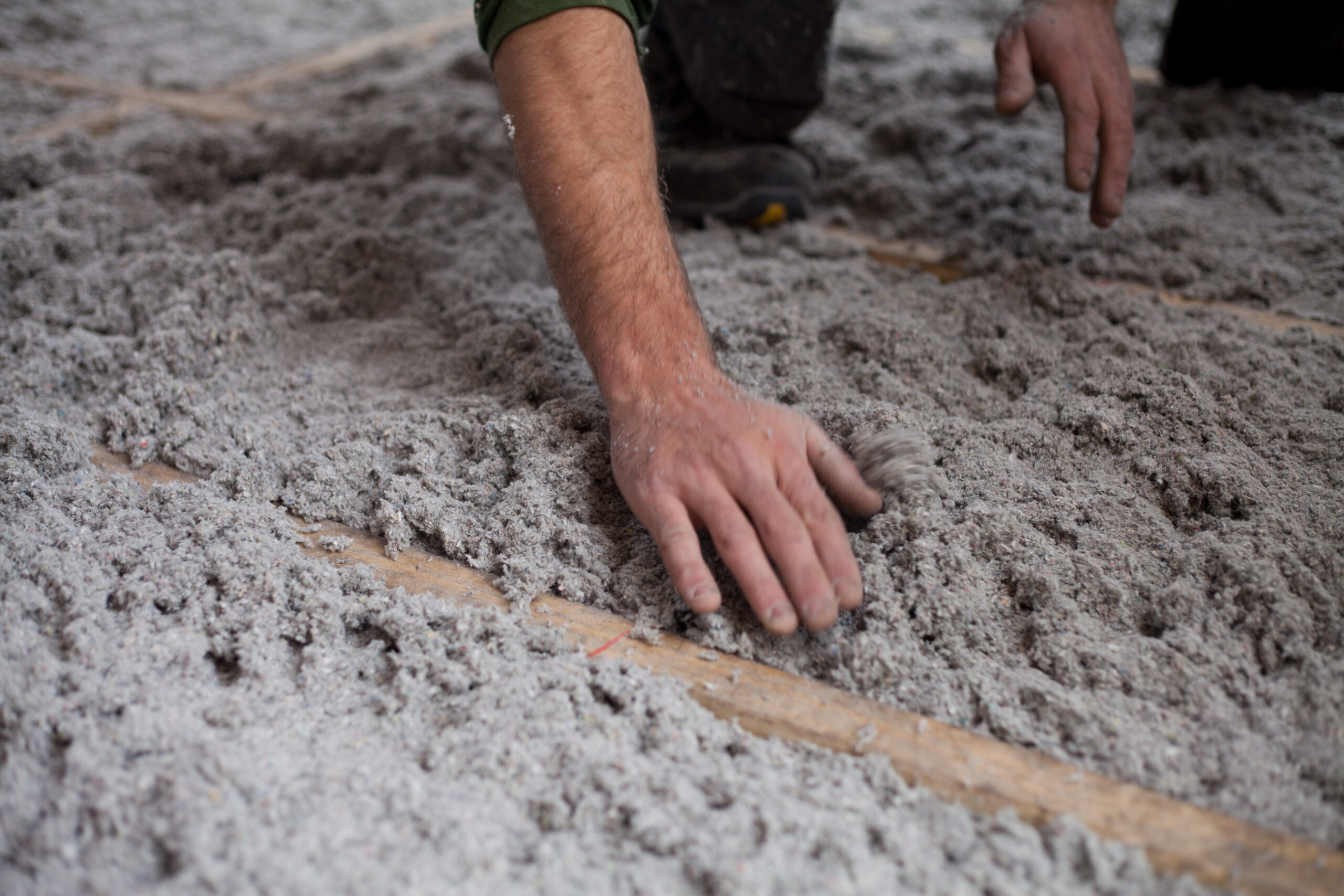 person's hand in eco friendly insulation