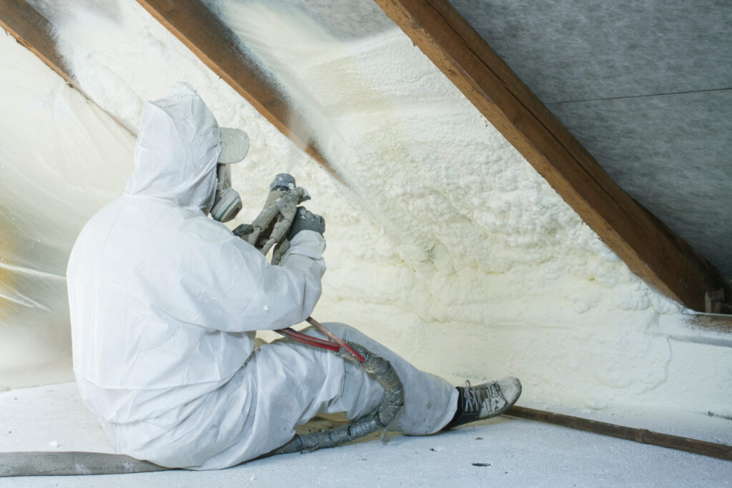 man using spray foam insulation